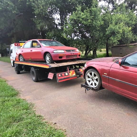 nyati towing a vehicle with a car loaded on their truck bed