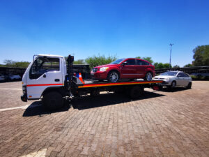 a vw golf and a dodge caliber being towed by nyati